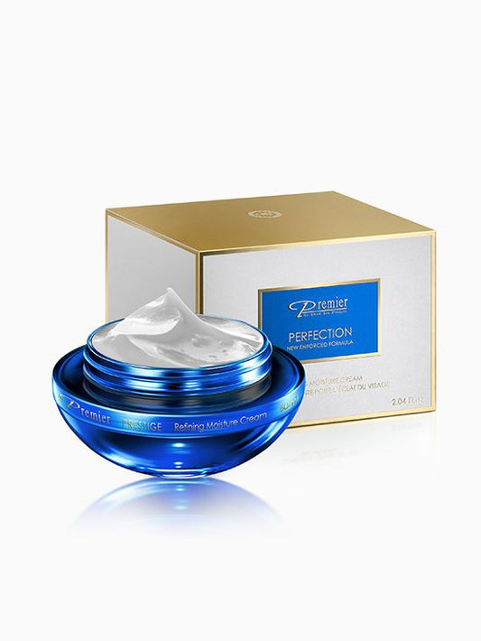Crema Perfection Refining Moisture de Premier de 60 ml en tarro azul abierto junto a su caja blanca y dorada.