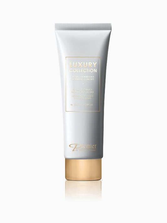 Limpiador facial con microgránulos Premier Luxury Collection en tubo gris con tapón dorado sobre fondo blanco.