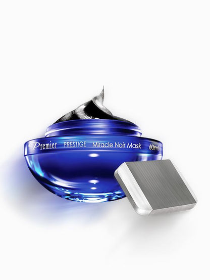 Mascarilla Milagro Negro de Premier Prestige de 60 ml en tarro azul abierto con accesorio rectangular plateado.