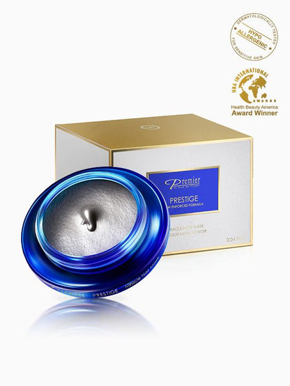Mascarilla Milagro Negro de Premier Prestige en tarro azul abierto con textura gris y caja blanca y dorada.